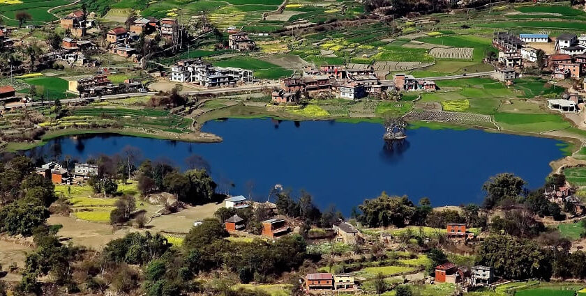 Taudaha Lake, a serene freshwater lake near Kathmandu, Nepal, surrounded by lush forest, home to migratory birds and local wildlife, reflecting peaceful natural beauty.