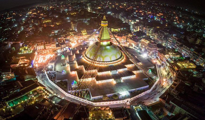 Boudhanath Stupa, one of the largest spherical stupas in the world, located in Kathmandu, Nepal, with its iconic all-seeing eyes of the Buddha, colorful prayer flags, and a bustling spiritual atmosphere.