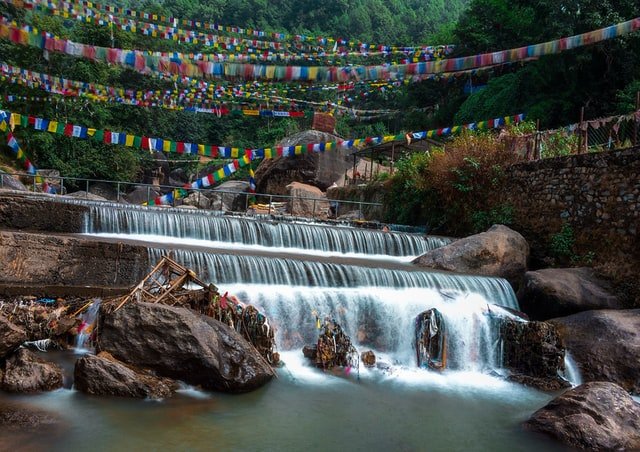 Bagmati River flowing through the Kathmandu Valley, considered sacred in Hinduism and Buddhism, with temples and ghats along its banks and often used for religious ceremonies and cremations.